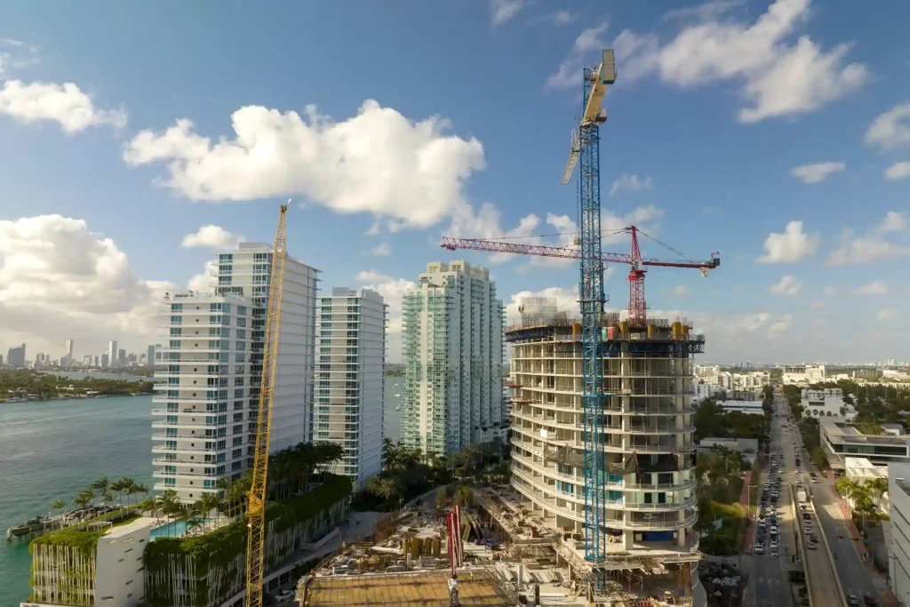 tower lifting cranes high residential apartment building construction site real estate development miami urban area 11zon